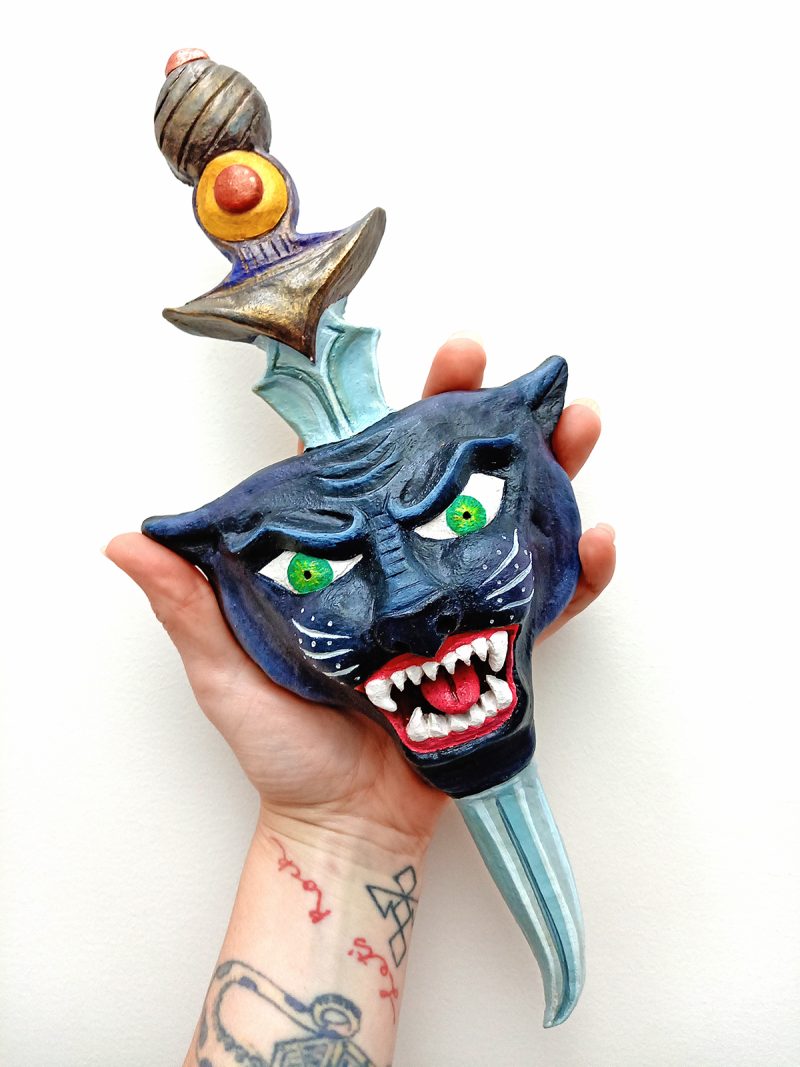 panther and dagger clay sculpture